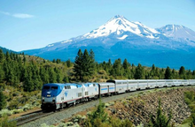 photo of Amtrak train with volcano in background